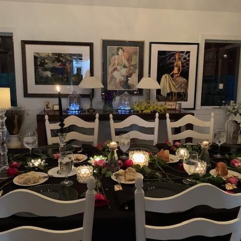 Dining Room with Setting of Black, Candles and Roses